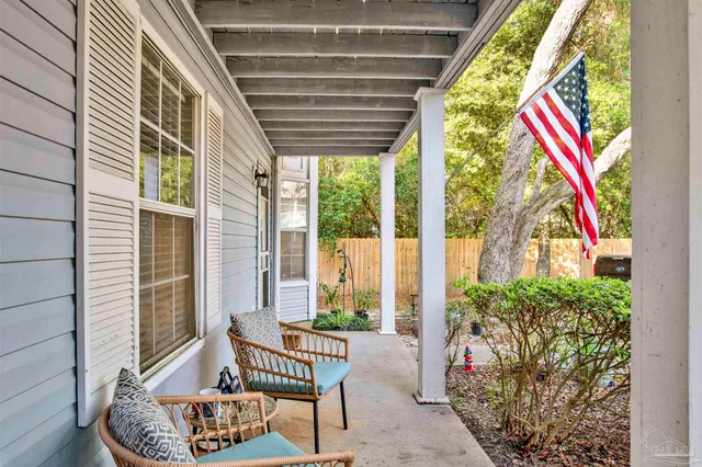 a front view of a house with outdoor seating