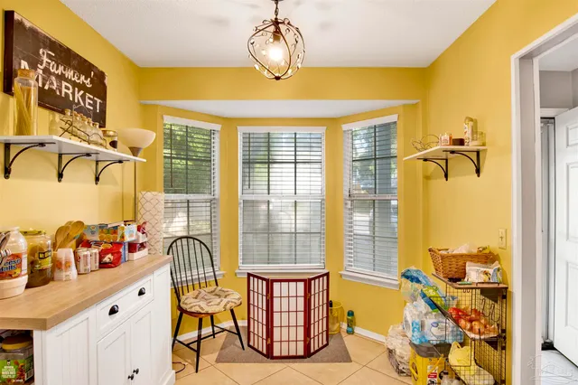 a dining room with furniture and a window