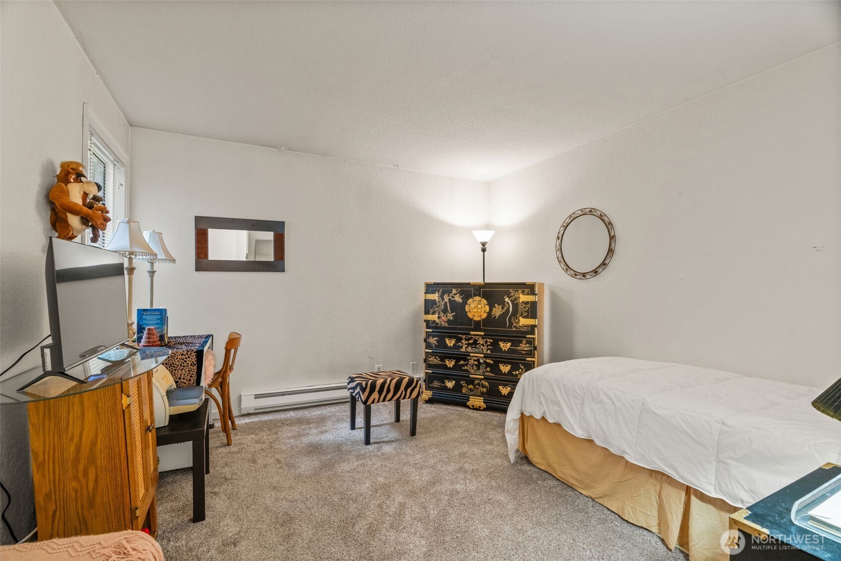 8517 242nd Street Southwest, Unit 402B Edmonds, WA 98026 - Photo 15 of 23 a bedroom with furniture and a window