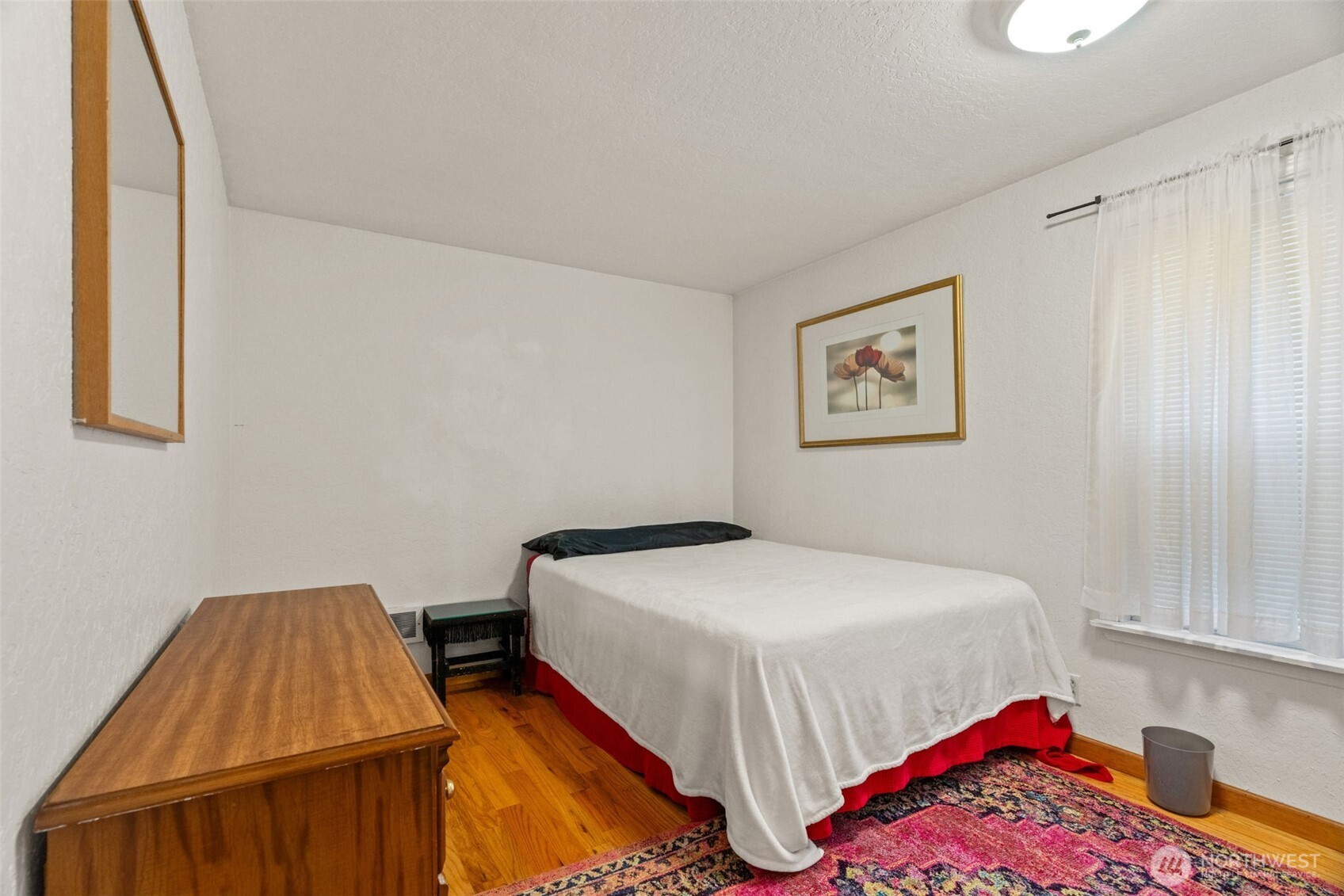 8517 242nd Street Southwest, Unit 402B Edmonds, WA 98026 - Photo 17 of 23 a bedroom with a bed and a dresser