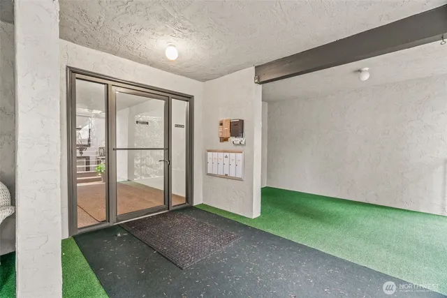 a view of small house with a yard and sitting area