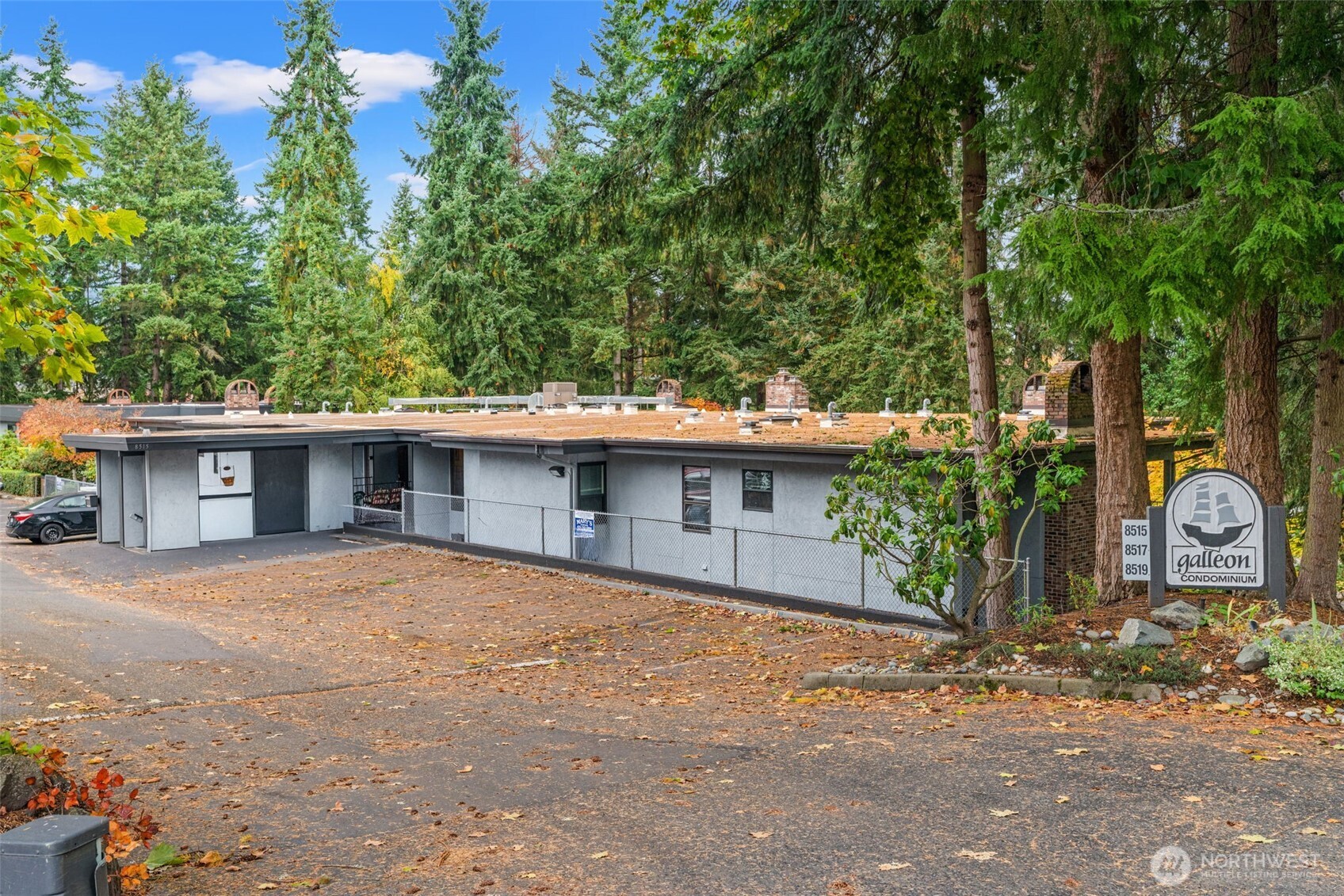 8517 242nd Street Southwest, Unit 402B Edmonds, WA 98026 - Photo 2 of 23 a front view of a house with a yard and trees