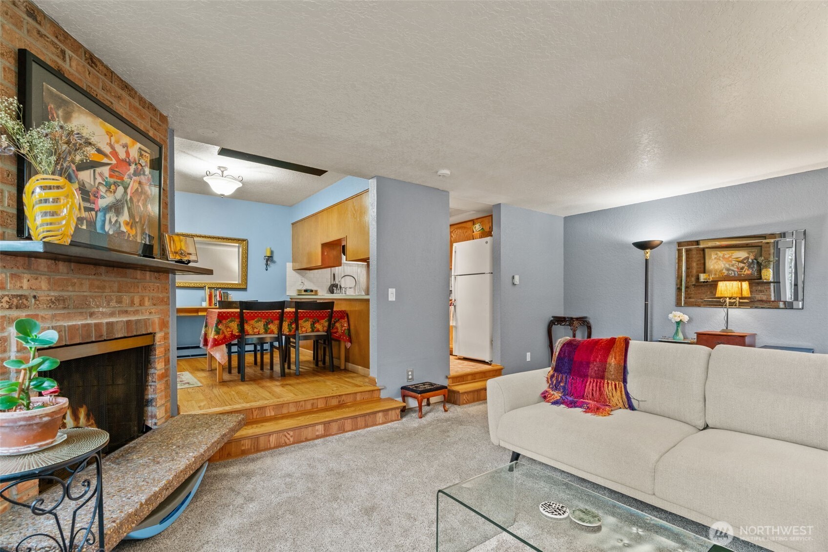 8517 242nd Street Southwest, Unit 402B Edmonds, WA 98026 - Photo 7 of 23 a living room with furniture and a fireplace