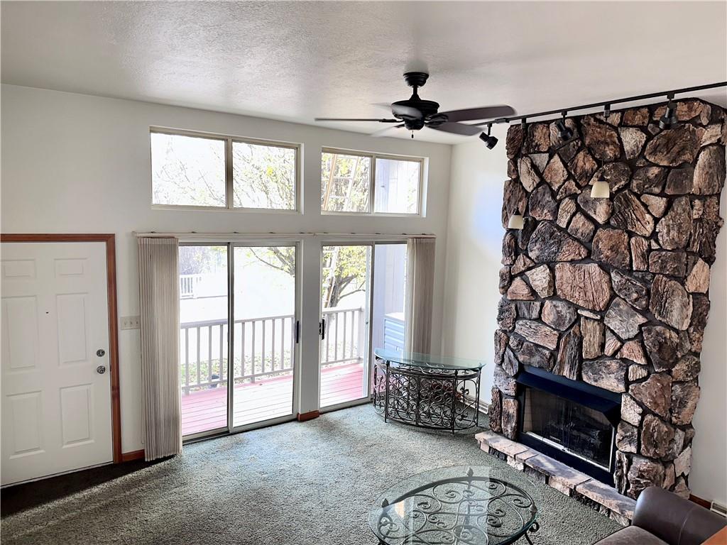 1099 Riverside Drive, Unit A Beaver, PA 15009 - Photo 14 of 49 a living room with a fireplace furniture a flat screen tv and a large window