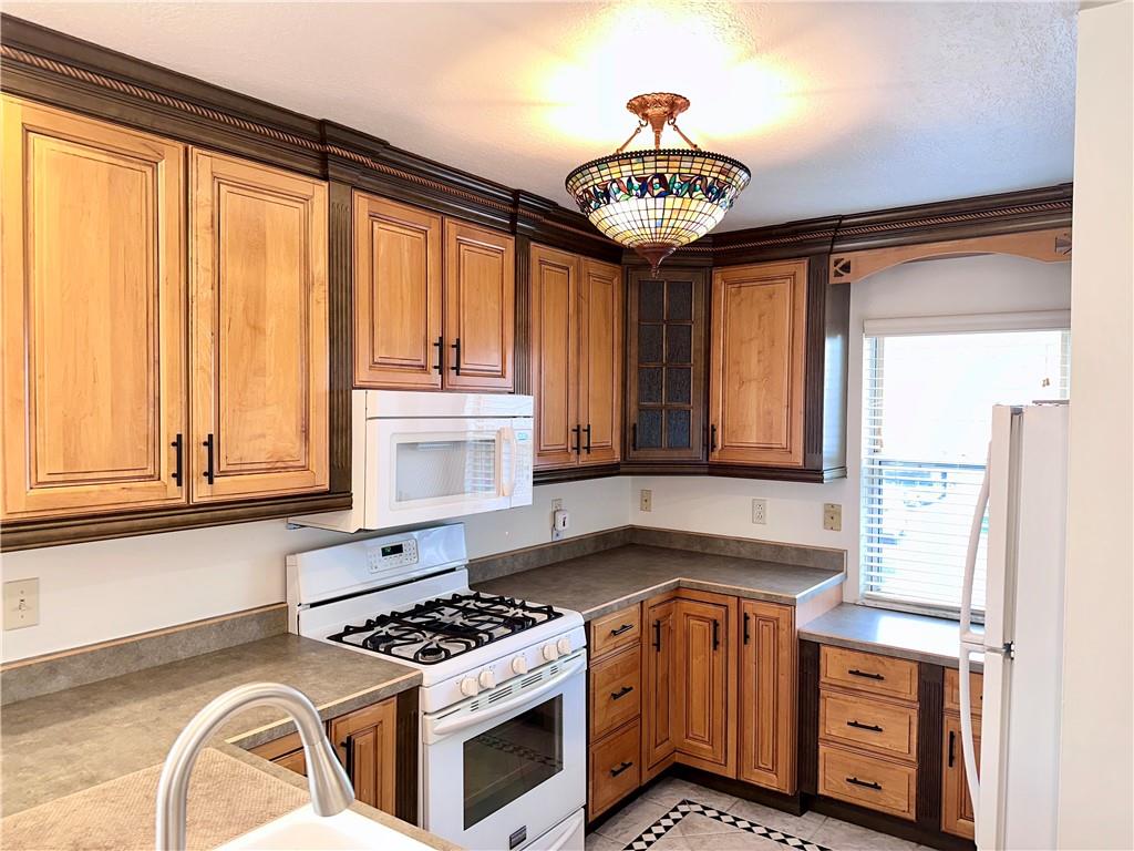 1099 Riverside Drive, Unit A Beaver, PA 15009 - Photo 2 of 49 a kitchen with stainless steel appliances granite countertop a stove a sink and a microwave