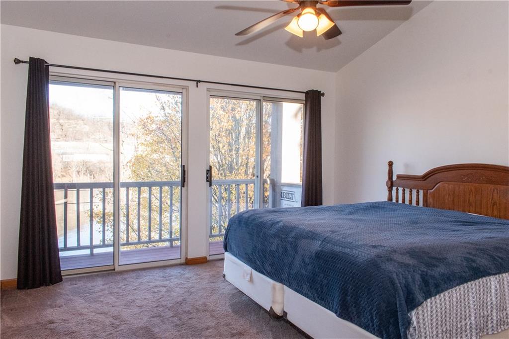 1099 Riverside Drive, Unit A Beaver, PA 15009 - Photo 28 of 49 a bedroom with a bed and a large window