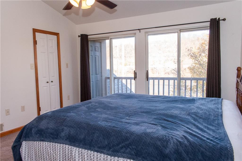 1099 Riverside Drive, Unit A Beaver, PA 15009 - Photo 29 of 49 a view of a bedroom with a bed and a chandelier fan
