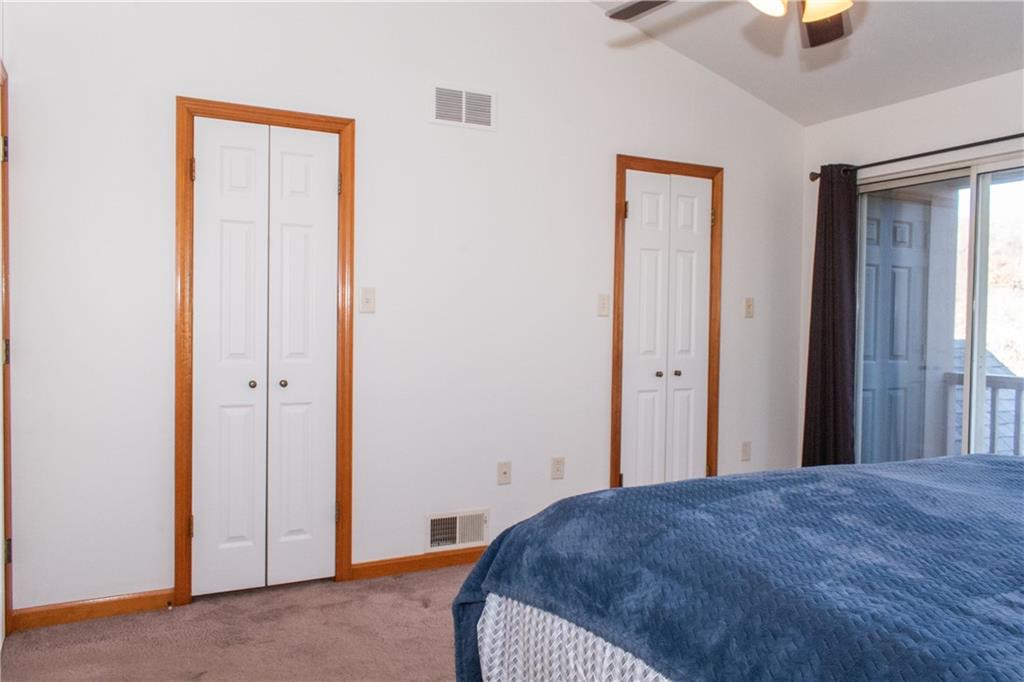 1099 Riverside Drive, Unit A Beaver, PA 15009 - Photo 30 of 49 a bedroom with a bed and painting on the wall