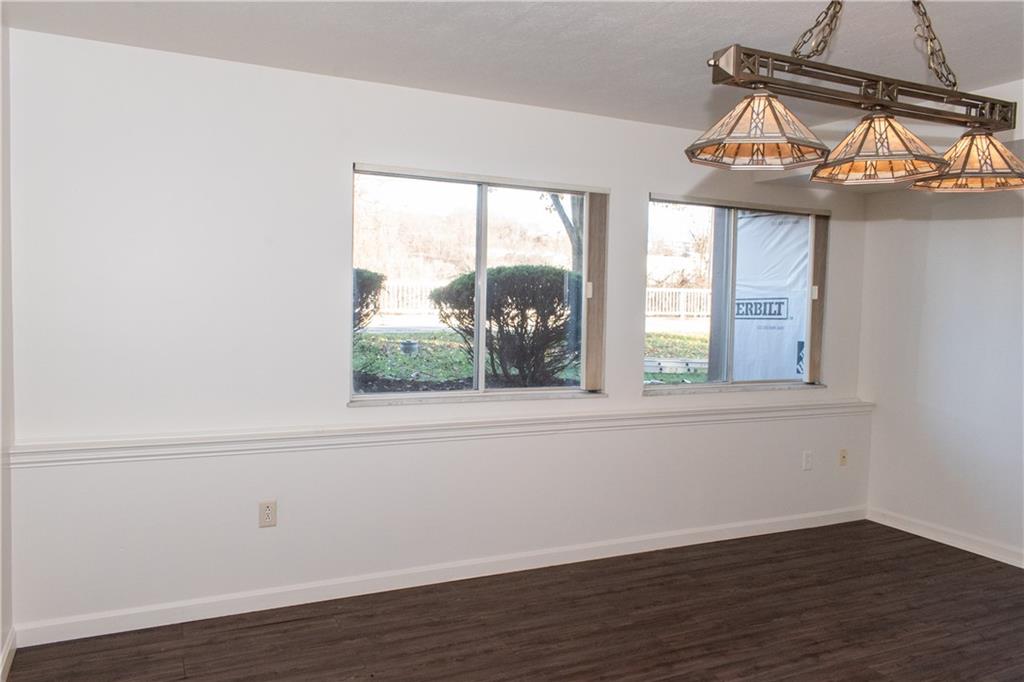 1099 Riverside Drive, Unit A Beaver, PA 15009 - Photo 40 of 49 an empty room with wooden floor fan and windows