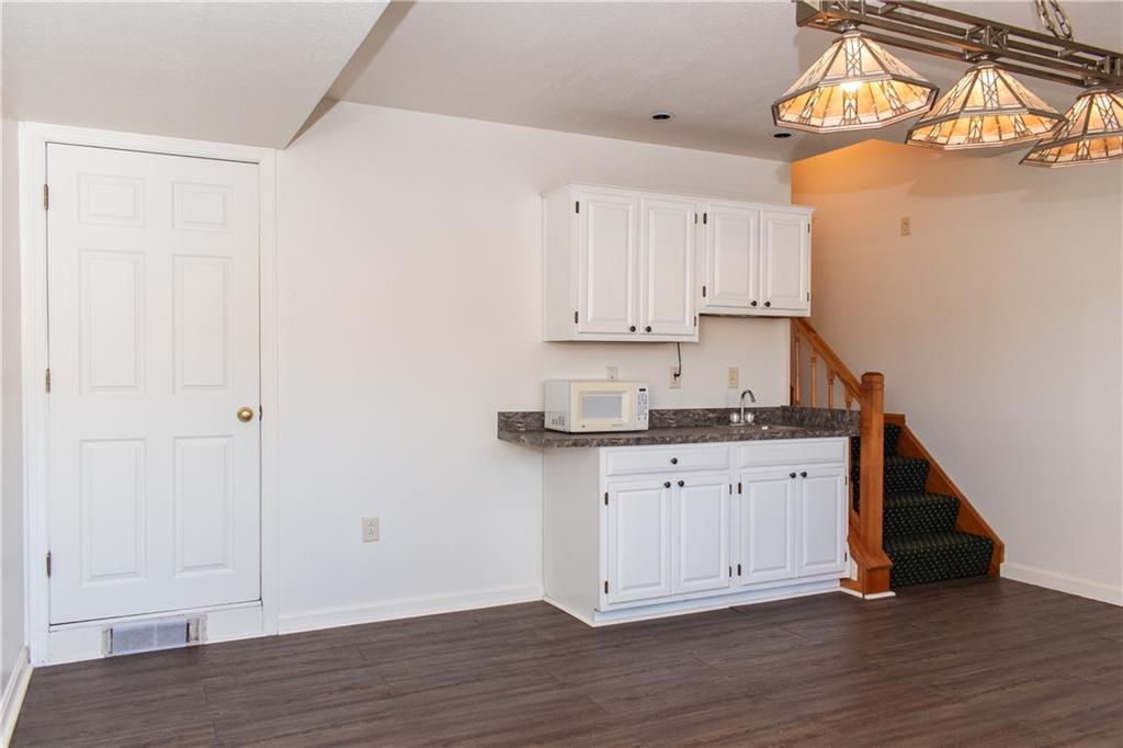 1099 Riverside Drive, Unit A Beaver, PA 15009 - Photo 42 of 49 a kitchen with granite countertop white cabinets and a sink