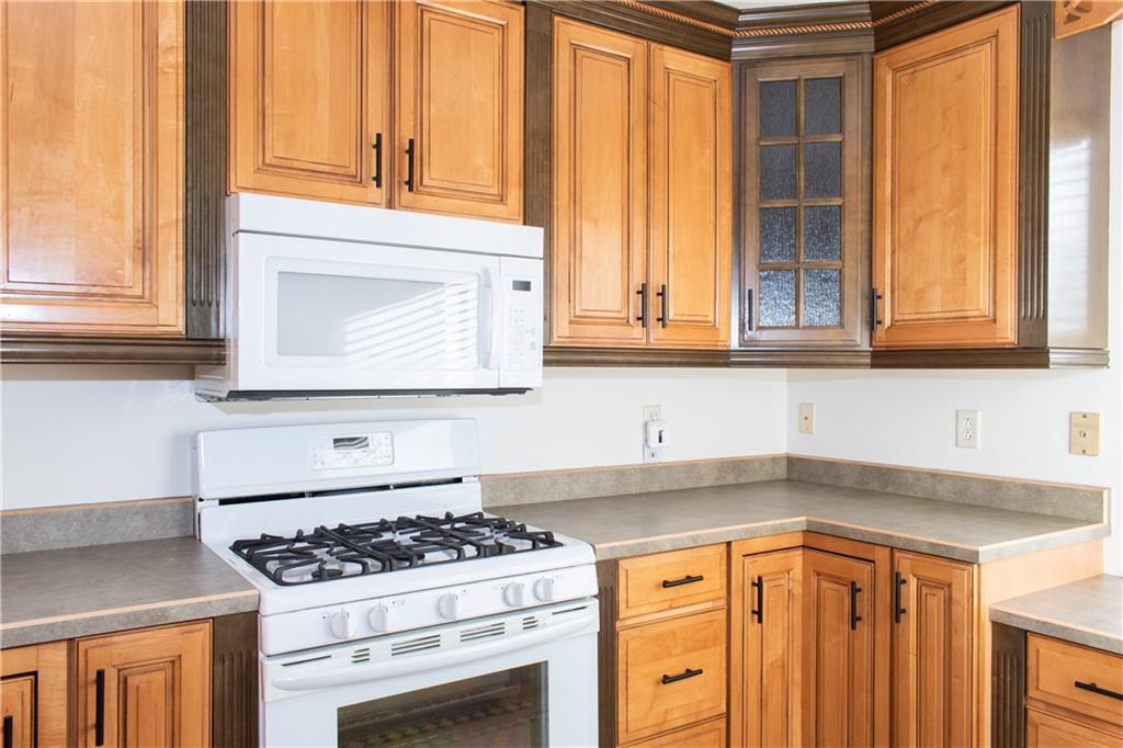 1099 Riverside Drive, Unit A Beaver, PA 15009 - Photo 5 of 49 a kitchen with stainless steel appliances granite countertop white cabinets and a stove top oven