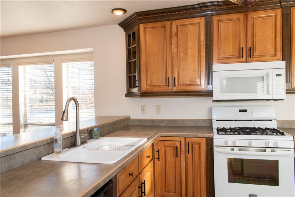 1099 Riverside Drive, Unit A Beaver, PA 15009 - Photo 7 of 49 a kitchen with granite countertop a stove sink and cabinets