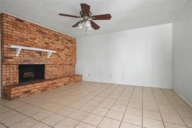 a view of an empty room with a fireplace