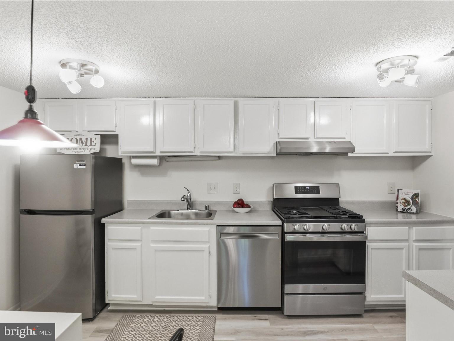 11809 Breton Court, Unit 2B Reston, VA 20191 - Photo 12 of 29 a kitchen with stainless steel appliances a stove a sink and cabinets