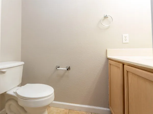 a white toilet sitting next to a shower
