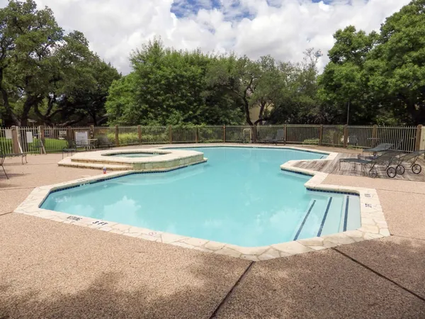 a view of a swimming pool with a lounge chair
