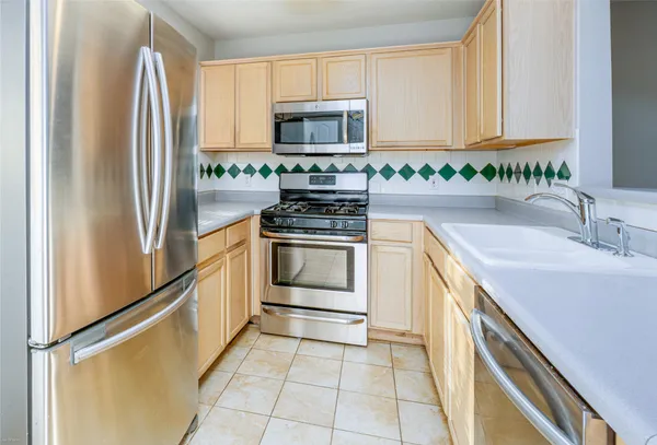 a kitchen with a sink stove and microwave