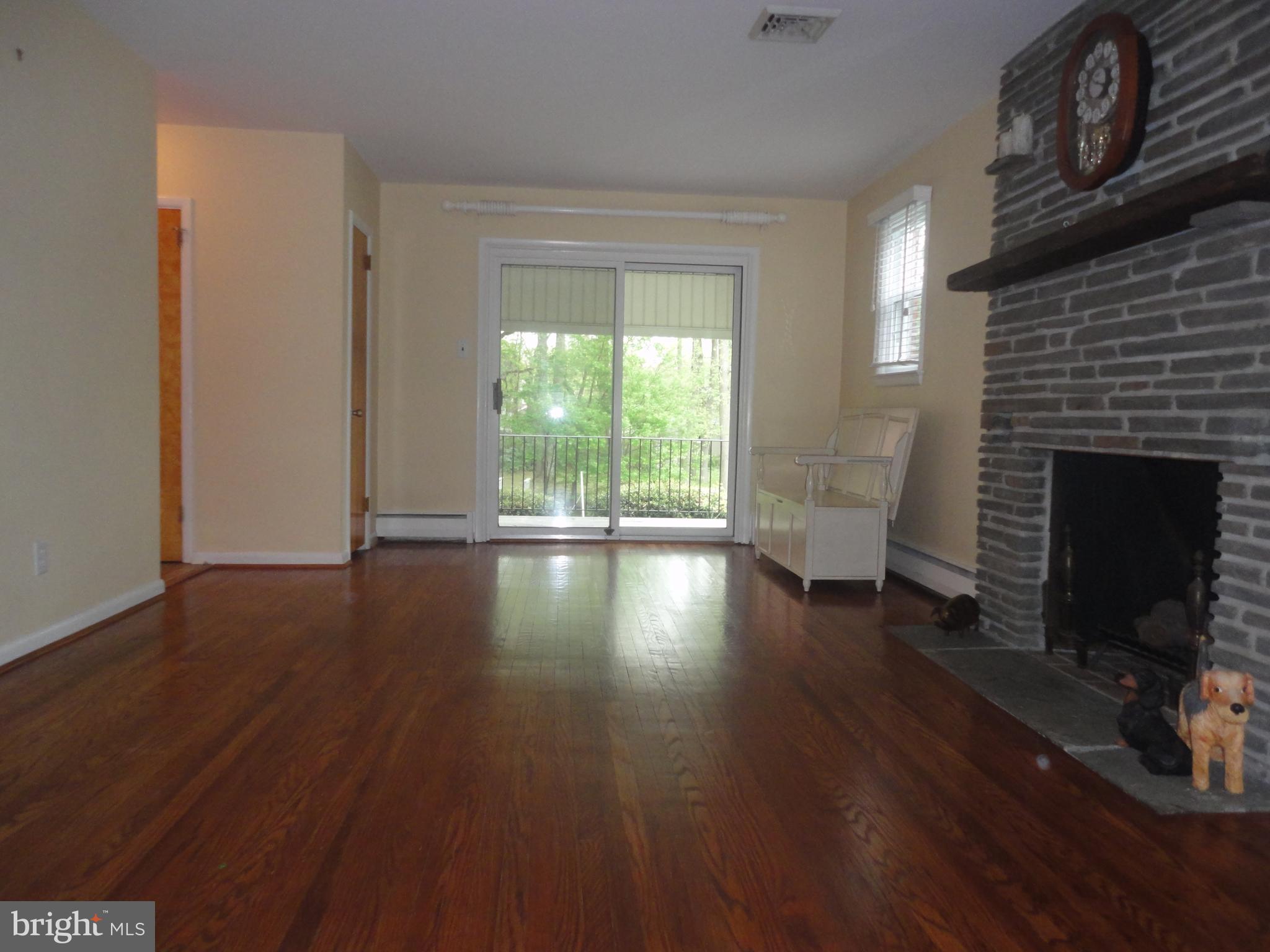 425 Garden Road Springfield, PA 19064 - Photo 3 of 28 a view of empty room with fireplace and wooden floor
