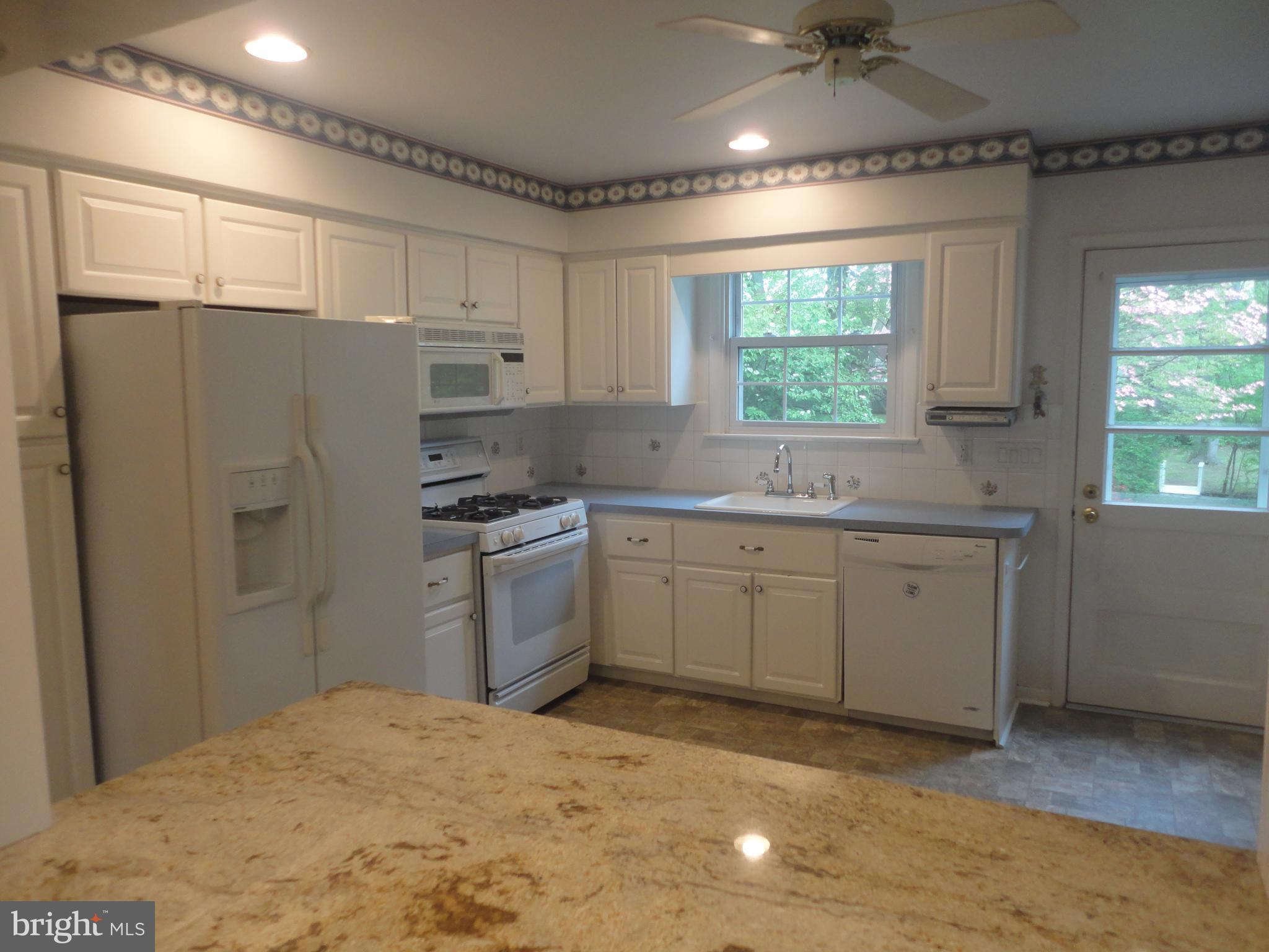 425 Garden Road Springfield, PA 19064 - Photo 8 of 28 a kitchen with a refrigerator sink and cabinets