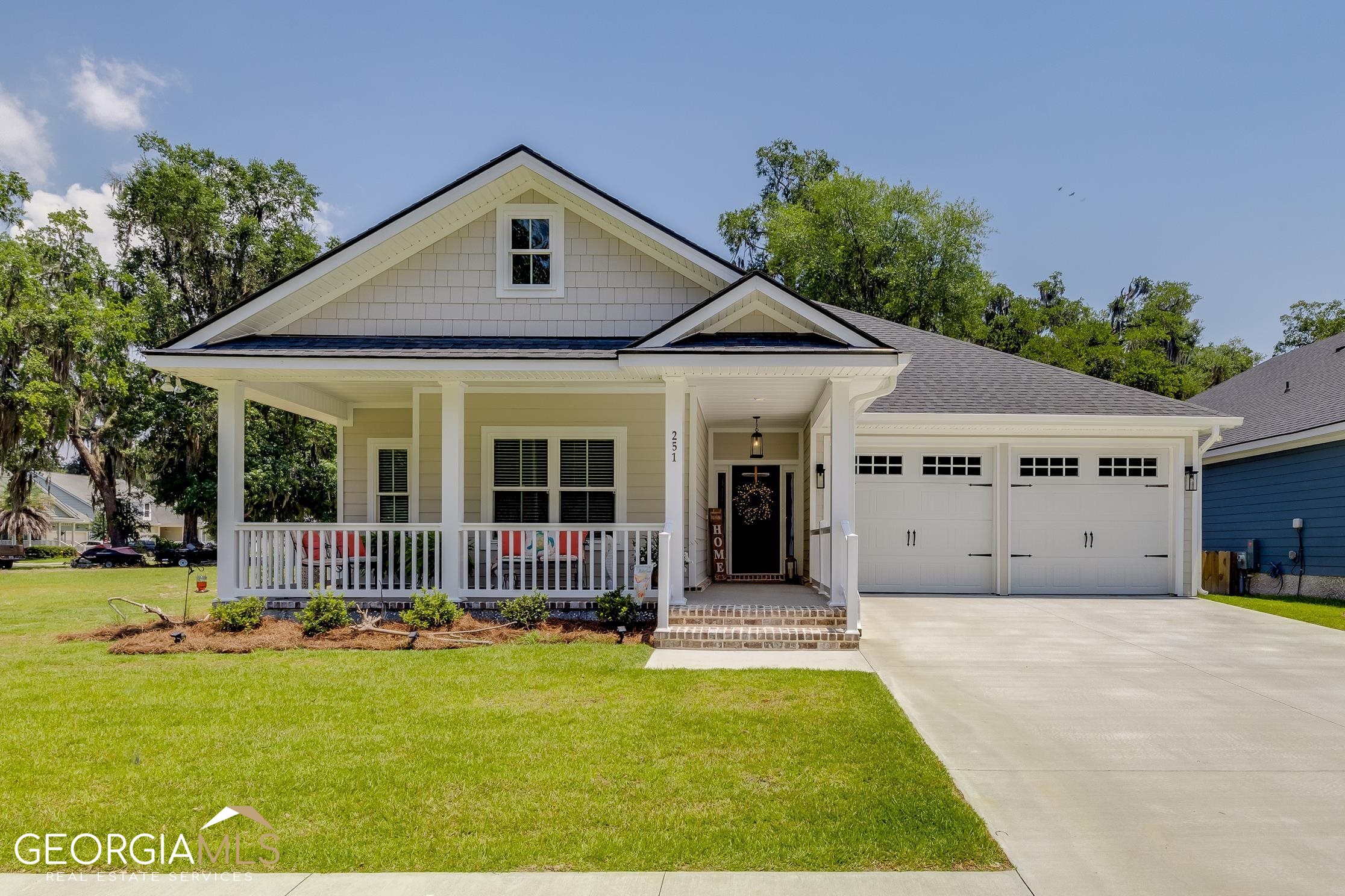 251 Village Road Midway, GA 31320 - Photo 1 of 1 a front view of a house with swimming pool and porch with furniture