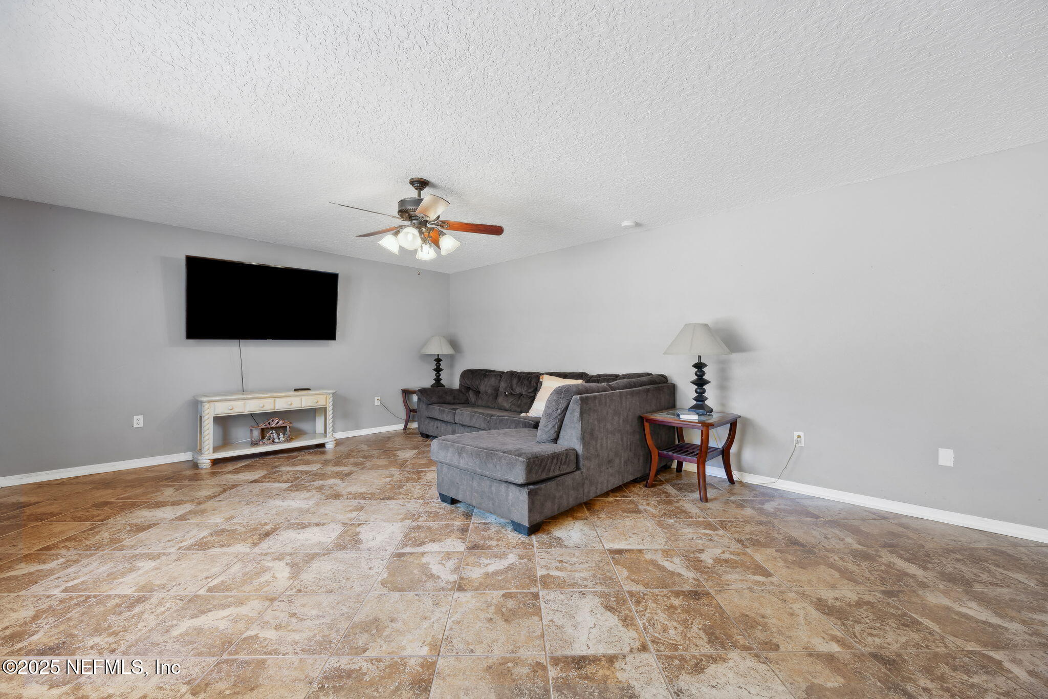 87002 Kip Lane Yulee, FL 32097 - Photo 15 of 54 a living room with furniture and a flat screen tv
