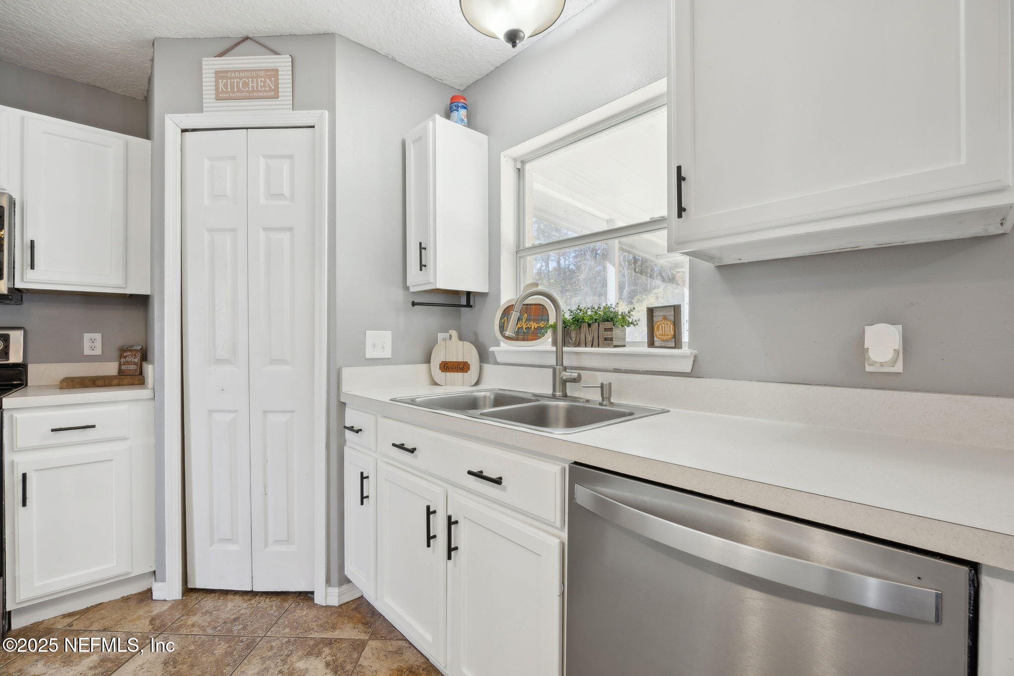 87002 Kip Lane Yulee, FL 32097 - Photo 17 of 54 a kitchen with a sink cabinets and appliances