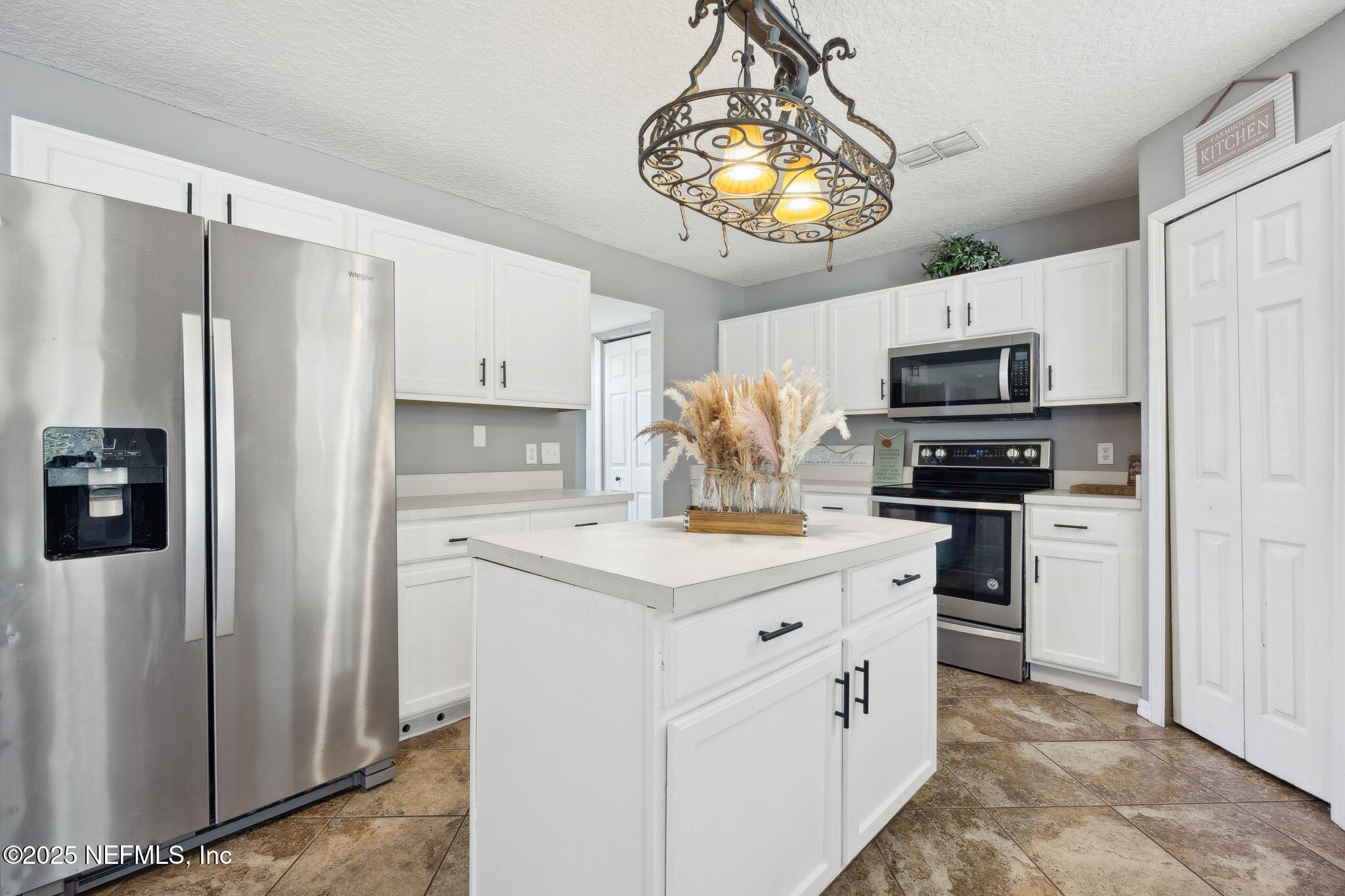 87002 Kip Lane Yulee, FL 32097 - Photo 2 of 54 a kitchen with stainless steel appliances a refrigerator stove and microwave