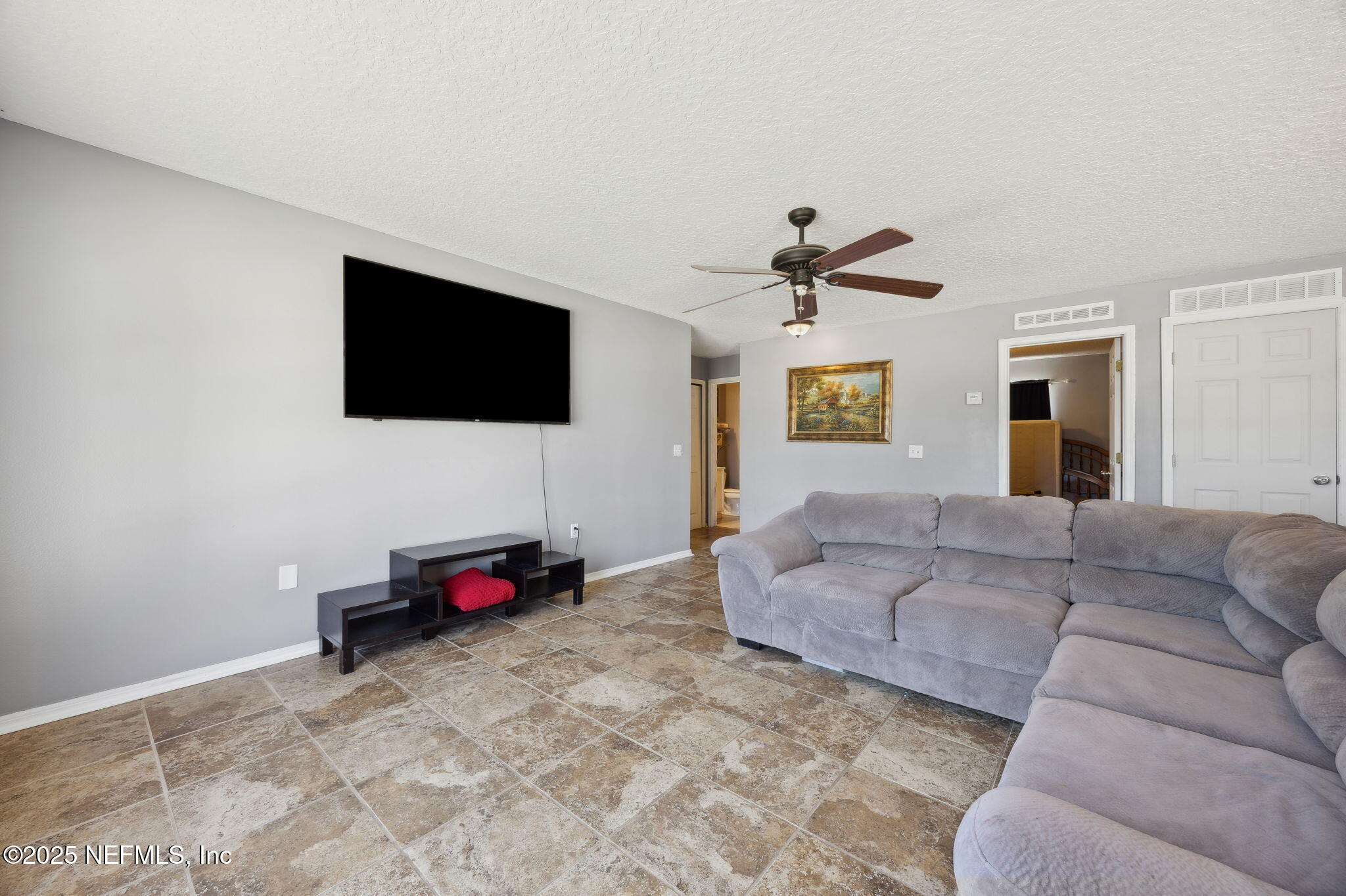 87002 Kip Lane Yulee, FL 32097 - Photo 23 of 54 a living room with furniture and a flat screen tv