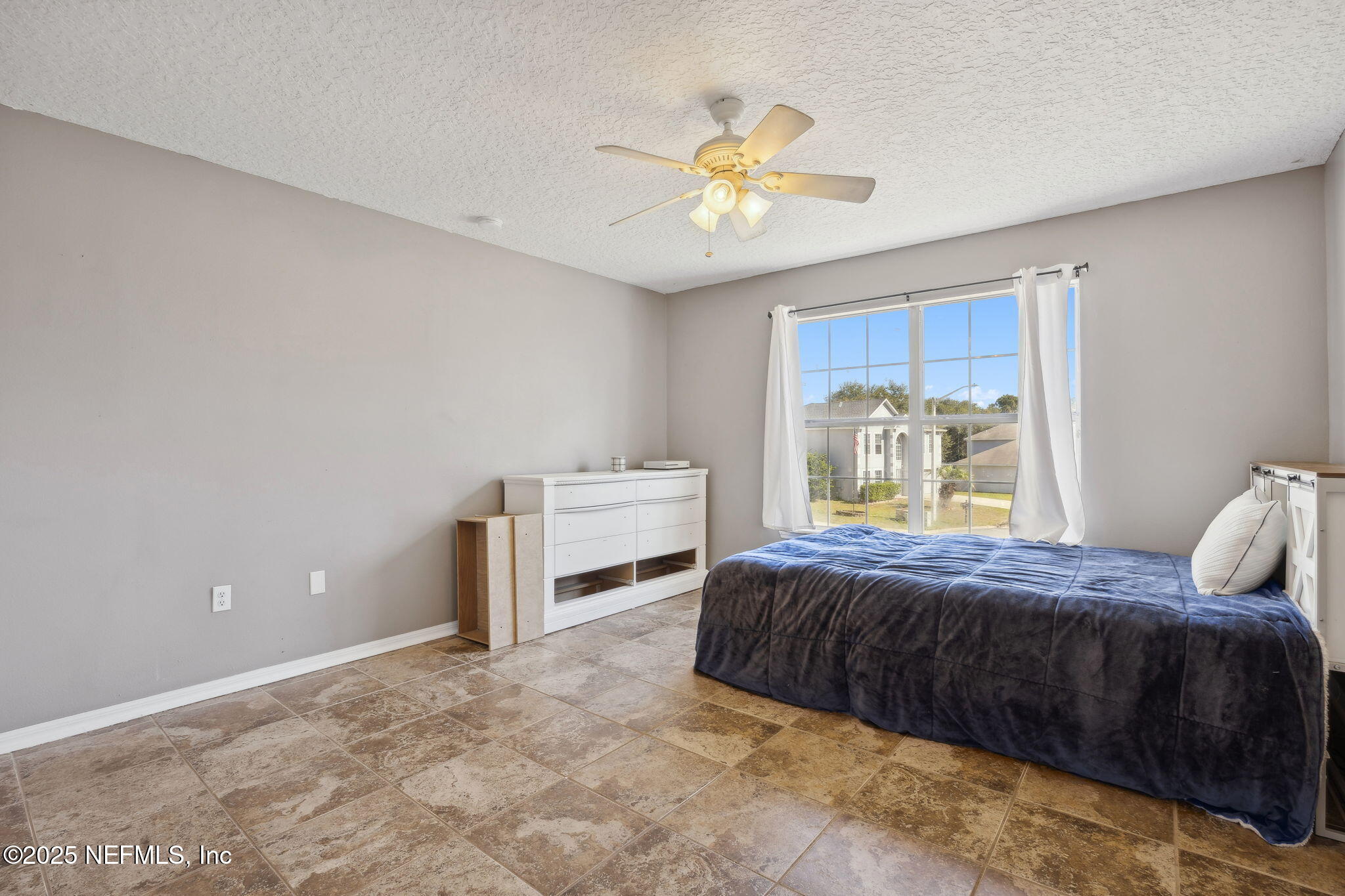 87002 Kip Lane Yulee, FL 32097 - Photo 29 of 54 a bedroom with a bed and ceiling fan