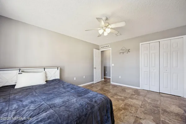 a living room with flat screen tv and a dresser
