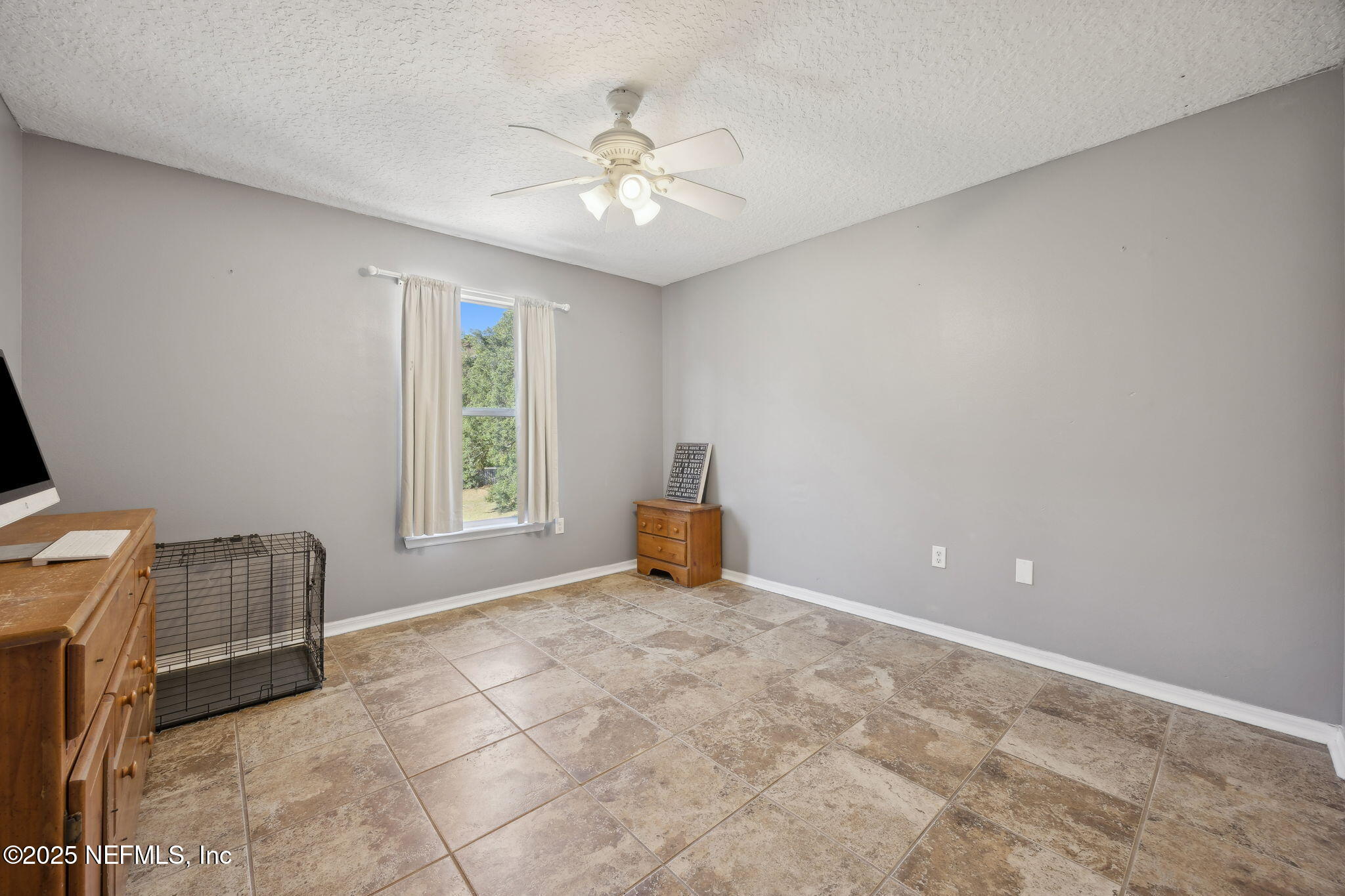 87002 Kip Lane Yulee, FL 32097 - Photo 31 of 54 a view of an empty room with window and chandelier fan