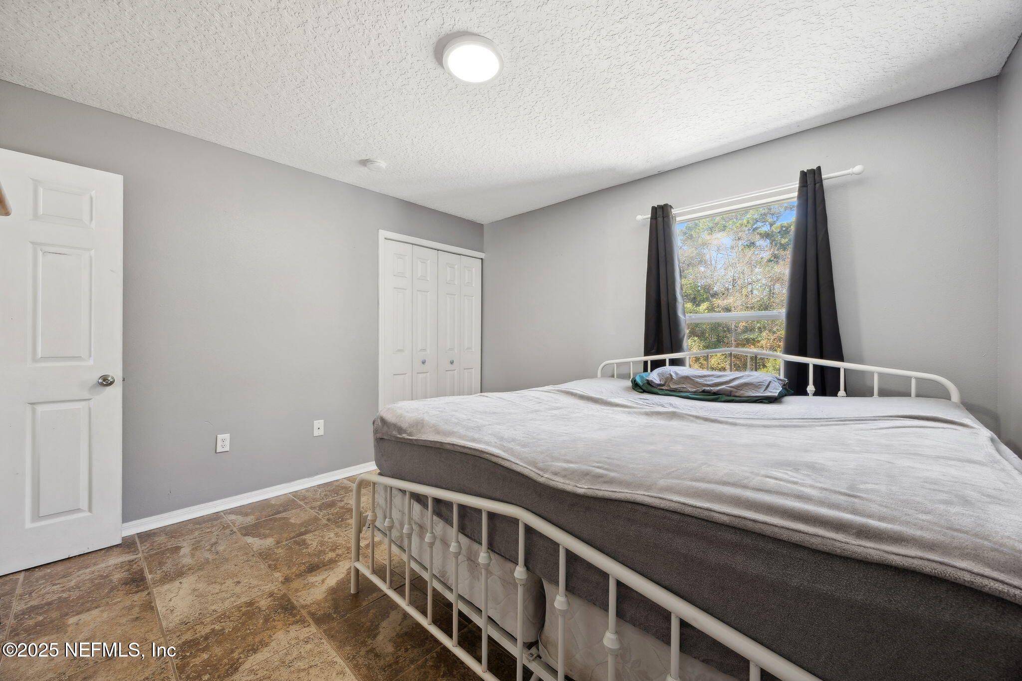 87002 Kip Lane Yulee, FL 32097 - Photo 34 of 54 a bedroom with a bed and a window