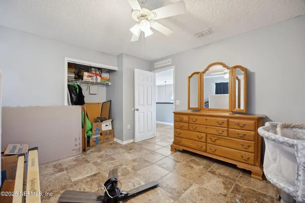 a view of a house with a big yard and large trees