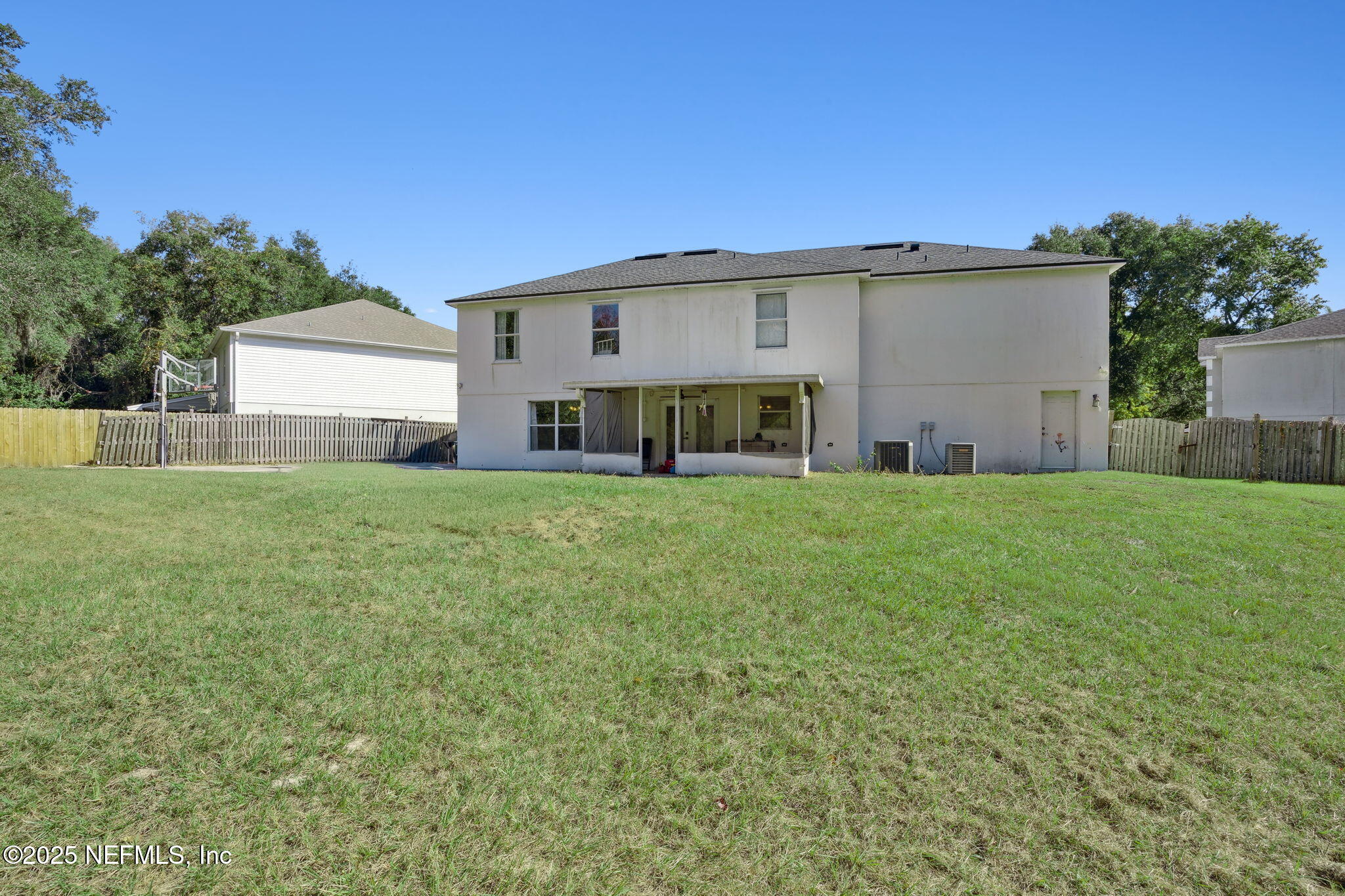 87002 Kip Lane Yulee, FL 32097 - Photo 39 of 54 a view of a house with a big yard and large trees