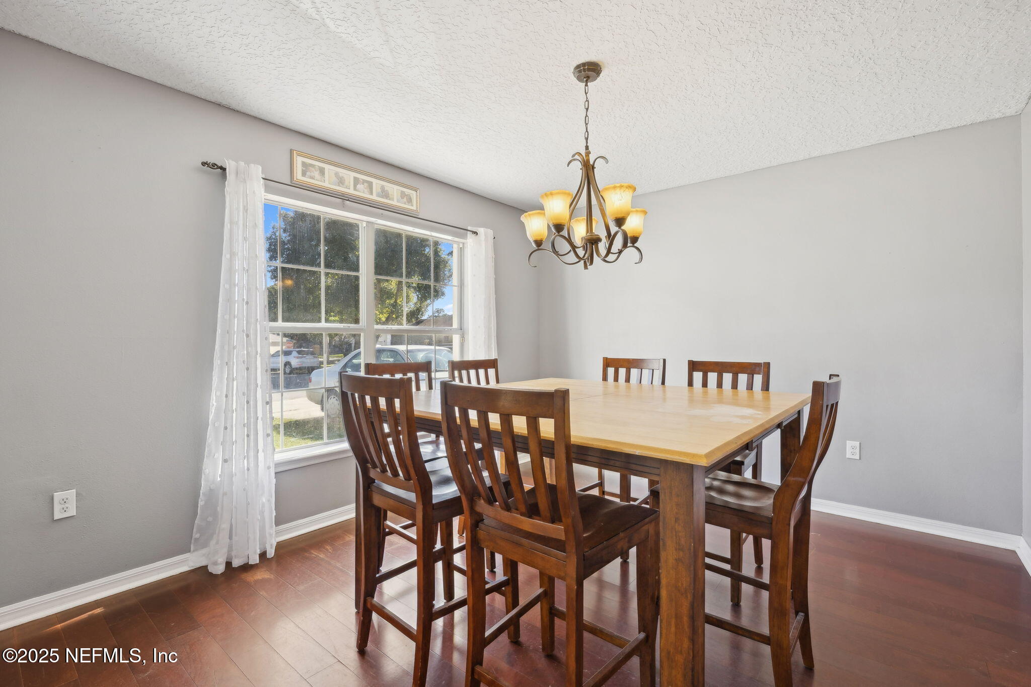87002 Kip Lane Yulee, FL 32097 - Photo 4 of 54 a view of a dining room with furniture wooden floor and chandelier