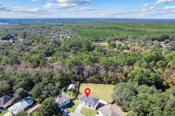 an aerial view of a houses with a yard