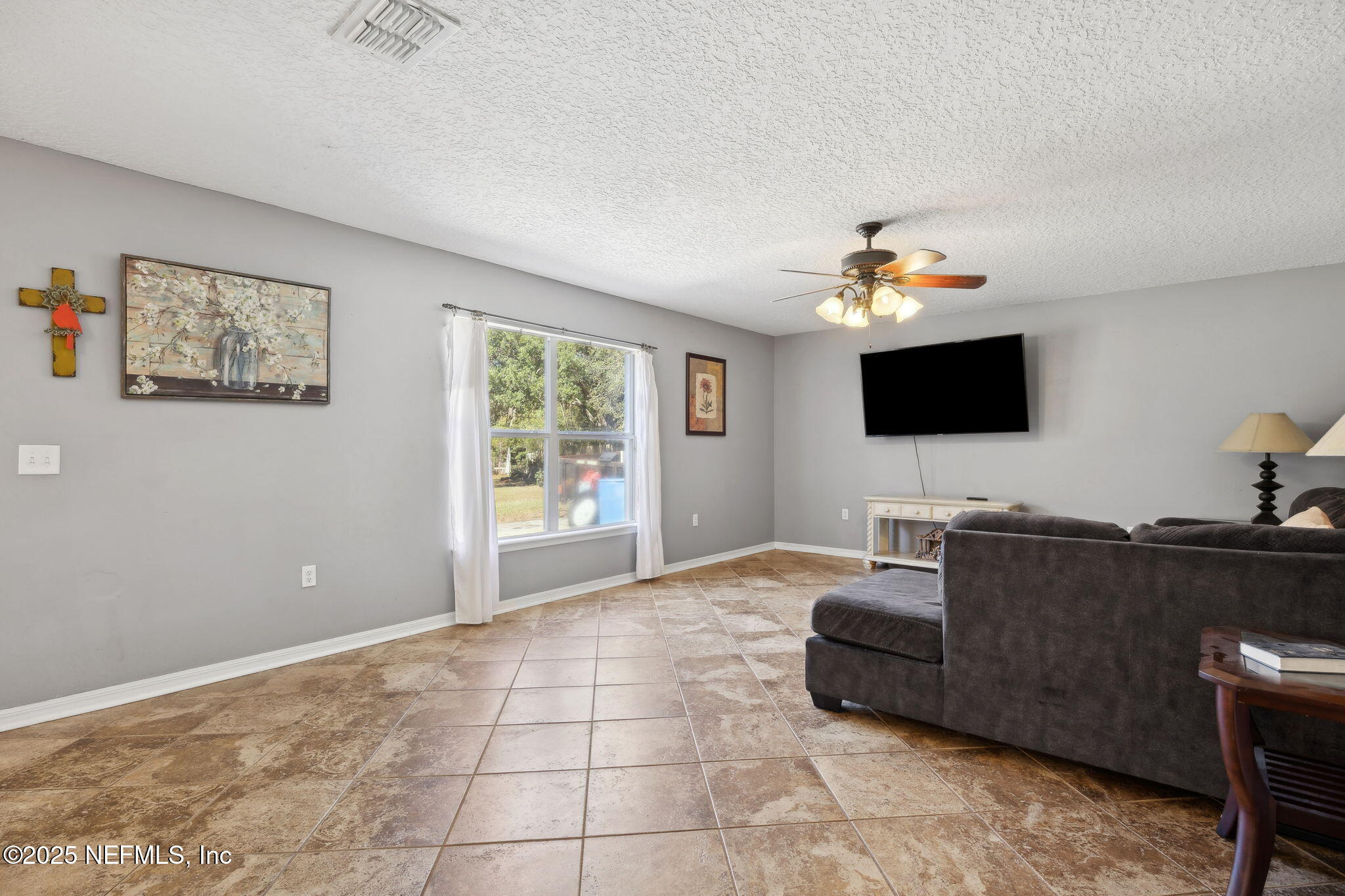 87002 Kip Lane Yulee, FL 32097 - Photo 5 of 54 a living room with furniture and a flat screen tv