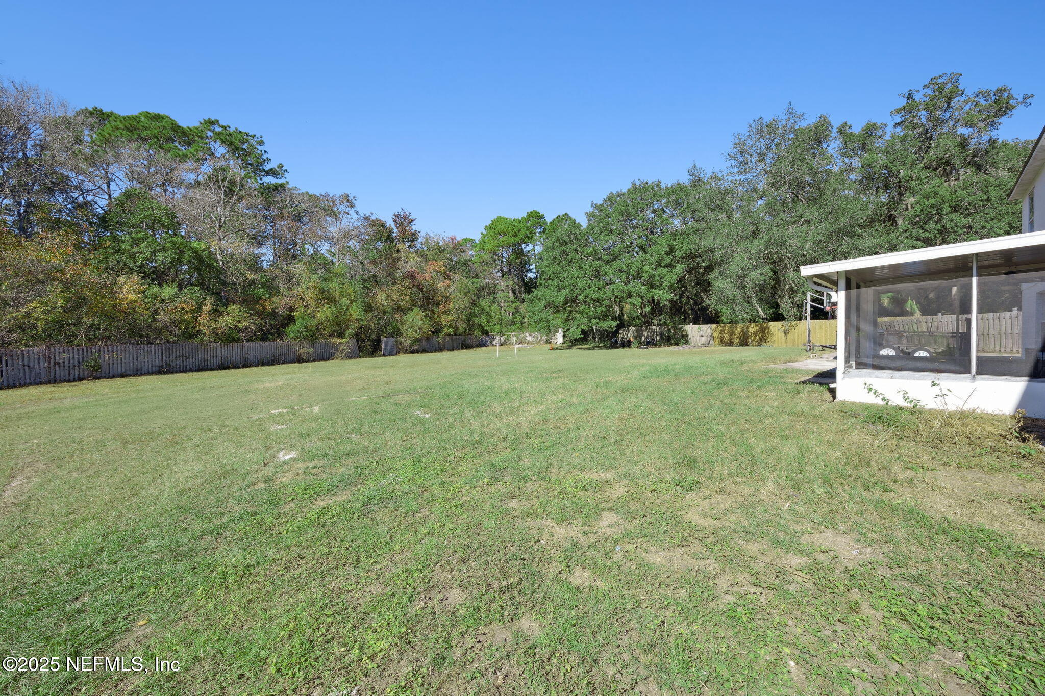 87002 Kip Lane Yulee, FL 32097 - Photo 6 of 54 a view of a grassy field with trees in the background
