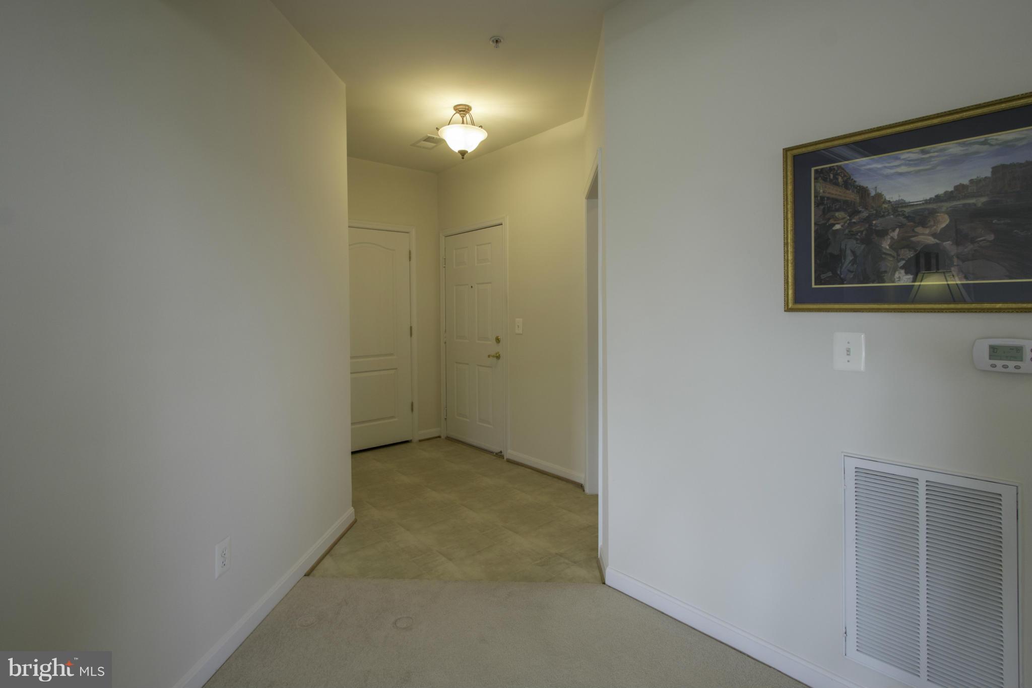 8601 Roaming Ridge Way, Unit 403 Odenton, MD 21113 - Photo 4 of 30 Spacious Foyer with 2 large storage closets