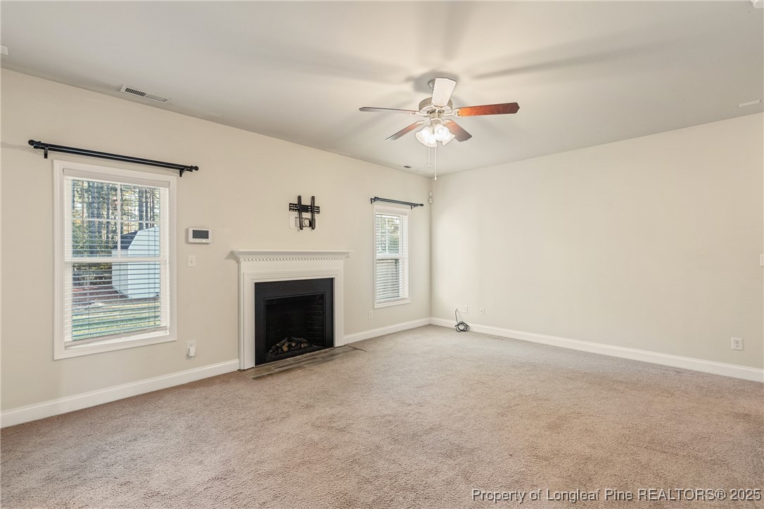 305 Home Stretch Lane Raeford, NC 28376 - Photo 16 of 35 a view of an empty room with a fireplace and a window