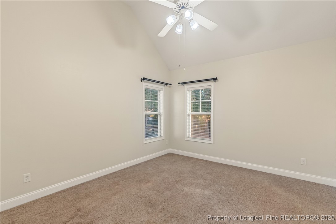 305 Home Stretch Lane Raeford, NC 28376 - Photo 28 of 35 an empty room with windows and chandelier fan