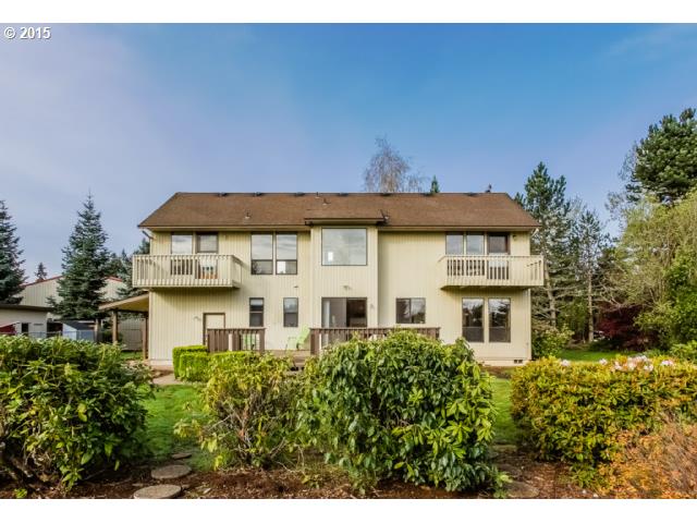 21240 South Springwater Road Estacada, OR 97023 - Photo 11 of 16 a view of a white house with large windows and a yard with plants