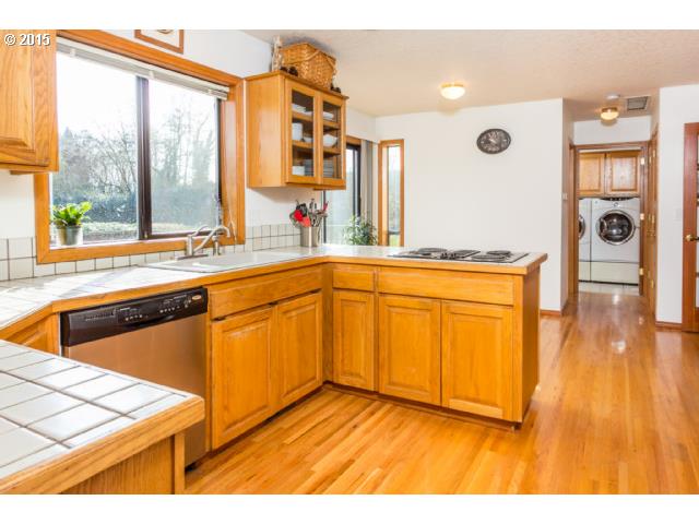 21240 South Springwater Road Estacada, OR 97023 - Photo 6 of 16 a kitchen with stainless steel appliances granite countertop a stove a sink and a microwave