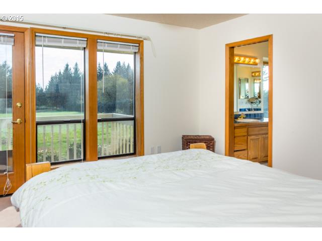 21240 South Springwater Road Estacada, OR 97023 - Photo 7 of 16 a bedroom with a bed and a large window