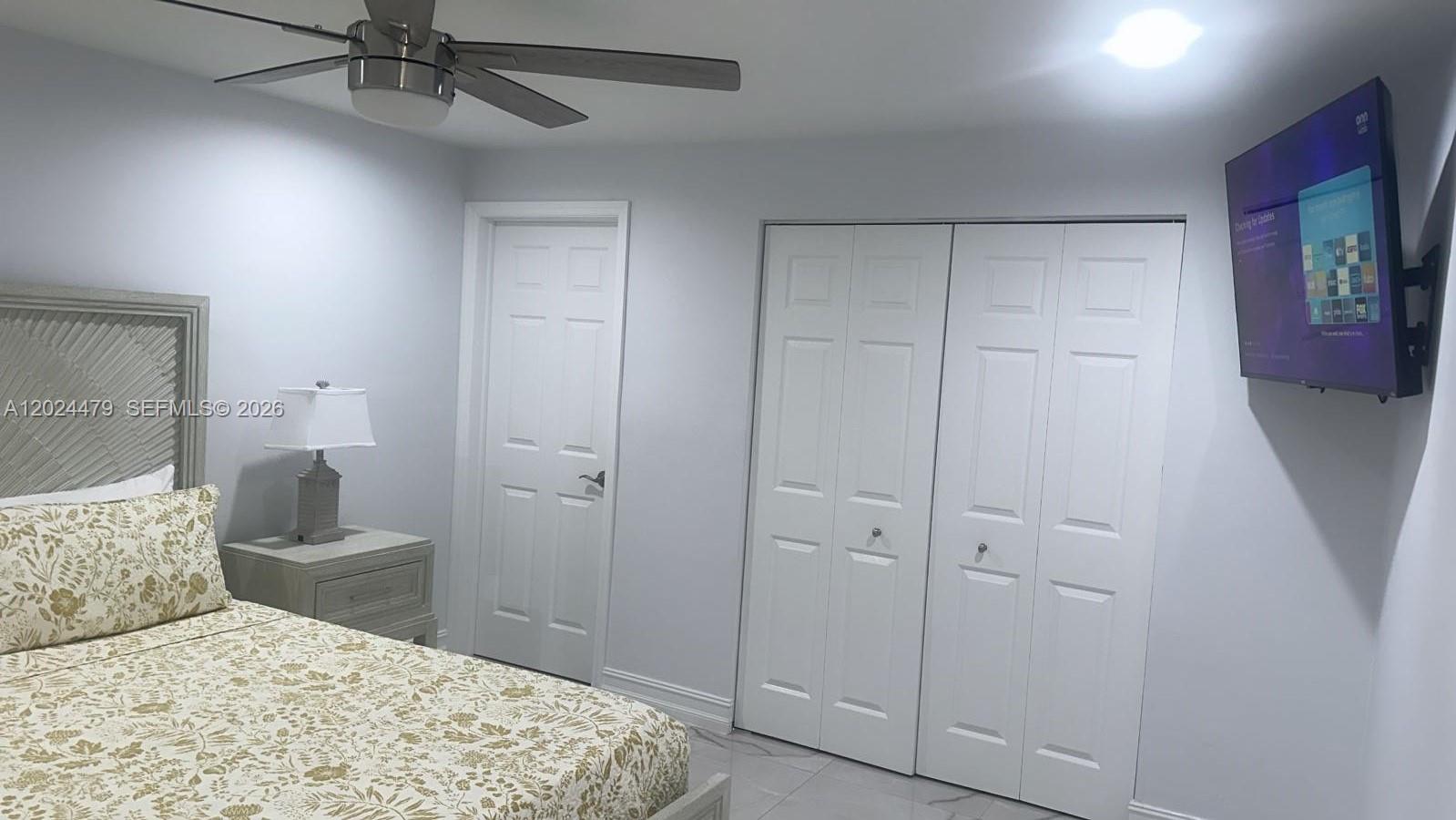 2212 Club House Road North Fort Myers, FL 33917 - Photo 15 of 40 a bedroom with a bed and a chandelier