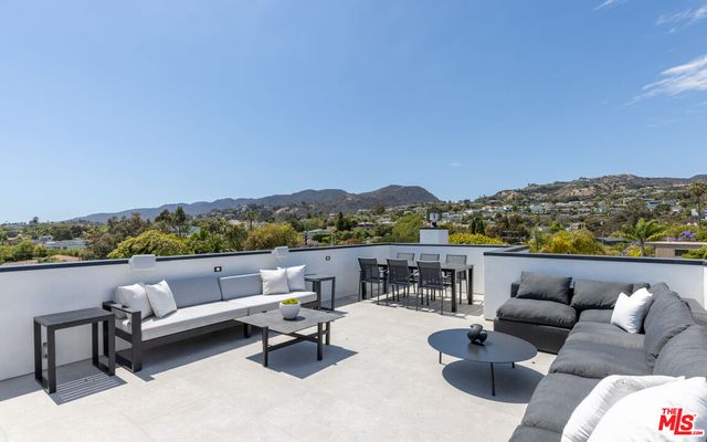 a terrace with couches and city view