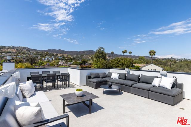 a view of a terrace with couches and lounge chair