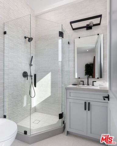 a spacious bathroom with a granite countertop sink mirror and toilet