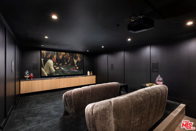 a media room with lots of chairs and a projector screen