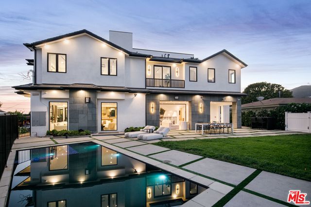 a large white building with a yard in front of it